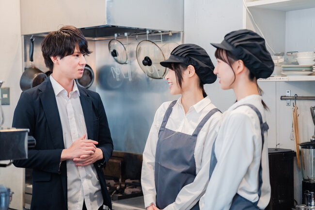 若い飲食店店員と打ち合わせする様子